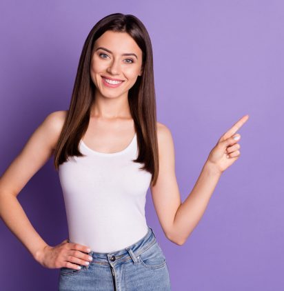 Photo,Portrait,Of,Smiling,Woman,Pointing,Finger,At,Blank,Space